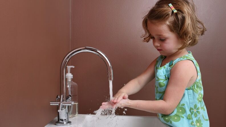 Girl washes her hands to prevent parasite infections